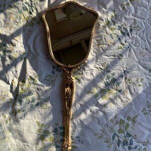 Elegant Gold Handheld Mirror in fair condition two spots on material on right